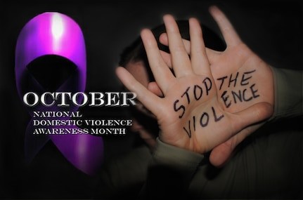 Purple ribbon and woman’s hands out protectively in front of her with writing Stop the Violence